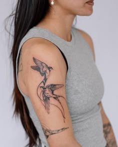 a woman with a bird tattoo on her arm