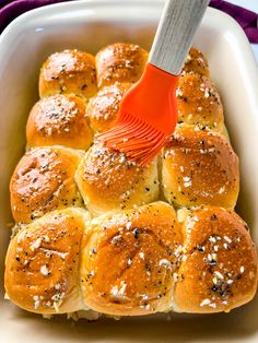 a spatula being used to stir hot cross buns in a casserole dish