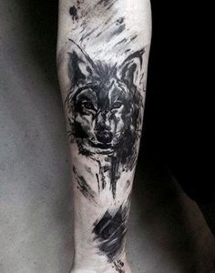 a black and white photo of a man's leg with a wolf tattoo on it