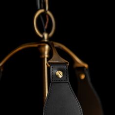 a black and gold purse hanging from a hook