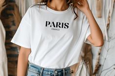 Paris France Chic T-Shirt, Feminine Cut Discover the enduring allure of Parisian chic with our graphic t-shirt inspired by modern fashion in France. As a dream destination for many, Paris radiates timeless charm, making this travel-inspired piece a must-have addition to your summer wardrobe! Made in the USA 🎨Design is professionally PRINTED directly onto the shirt (NOT VINYL) using commercial grade equipment for a long lasting shirt. Sizing/Measurements WHEN LAID FLAT, Length is from the highest point on the shoulder to the bottom of shirt. (times the chest measurement by 2 for full chest measurement around the shirt): Please use size chart as guide. Gildan Premium Women's Shirts run true to size but have a relaxed fit. If you want a loose roomy fit - go one size up. Please refer to size Fashion In France, Paris Girls Trip, Vacation In Paris, Parisienne Chic, Usa Design, Girls Trip Shirts, Aesthetic Shirt, Paris Mode, Aesthetic Shirts