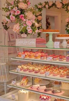 a display case filled with lots of cakes and cupcakes