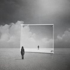 a person standing in front of a large mirror on the ground with clouds behind them