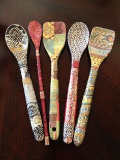 five spoons are lined up on a table with different patterns and designs painted on them