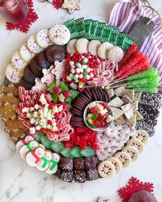 a platter filled with assorted candy and cookies