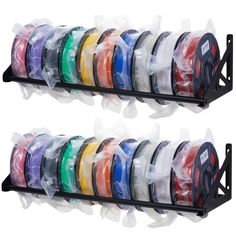 two rows of different colored tapes in plastic bags on black racks with white handles and one row of multicolored spools