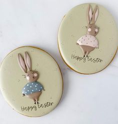 two cookies decorated to look like bunnies with happy easter written on the front and back