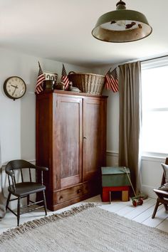 a bedroom with an armoire and american flags on it