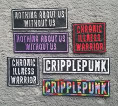 four patches with words on them that say, nothing about us without us and cripplepunk