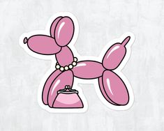 a pink balloon dog sticker sitting on top of a table