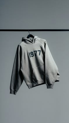 a gray sweatshirt hanging on a clothes line with the number seventy7 printed on it