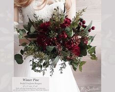 a woman in a white dress holding a bouquet of red flowers and greenery on her wedding day