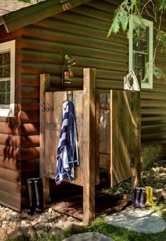 there is a small cabin in the woods with clothes hanging out to dry on it