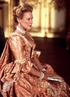 a woman in an orange dress sitting down