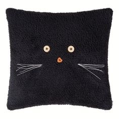 a black cat pillow with buttons on it