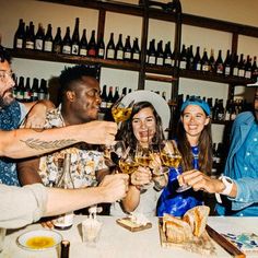 a group of people toasting with wine glasses