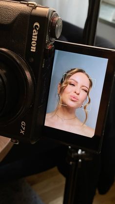 a camera with a woman's face on it and the image is being taken