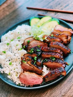 a blue plate topped with meat and rice