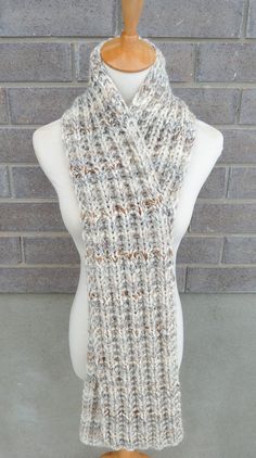 "This beautiful hand knitted scarf is made with Super Bulky and Soft Wool Blend Yarn (80% Acrylic, 20% Lambswool). Classic ribbed pattern, it looks the same on both sides. The scarf can be worn in multiple ways. Very beautiful colors: shades of off white, grey, and brown. The colors may appear slightly different on different monitors. Measures: 65\"- 67\" (165-170 cm) long x 7\" (18 cm) wide. From a smoke-free home. Care instructions: Hand wash in cool water and dry flat." One-size Acrylic Yarn Scarf Knitting Pattern, One Size Knitting Pattern For Acrylic Yarn Scarf, One Size Scarf Knitting Pattern, Hand Knitted Yarn Scarves, One Size White Crochet Knitting Pattern, Cozy Hand Knitted Yarn Scarves, White Hand Knitted Scarf One Size, Cozy Hand-knitted Scarves, Cozy Knitted Yarn Scarf