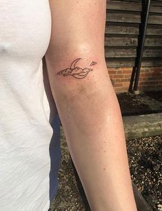 a person with a small tattoo on their arm