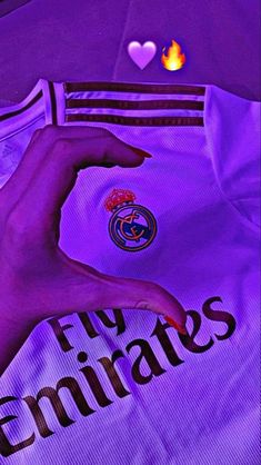 a person's hand on the chest of a purple soccer jersey that says, happy valentine's