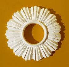 a white paper object on a yellow background with the shape of a sunburst