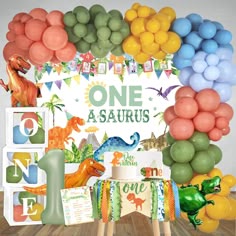 a dinosaur themed birthday party with balloons and decorations