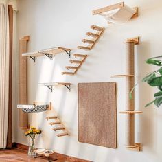 a cat tree and scratching board in the corner of a room with wooden shelves on the wall