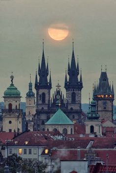 the full moon is seen over old buildings in prague, germany on may 25, 2012