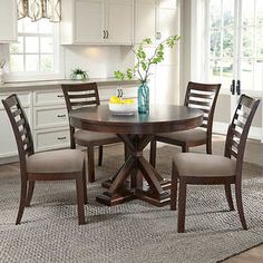 a kitchen table with four chairs around it