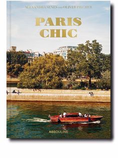 a book with the title paris chic written in gold on it, and a small boat