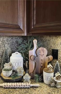 a kitchen counter topped with wooden cutting boards and christmas decorations