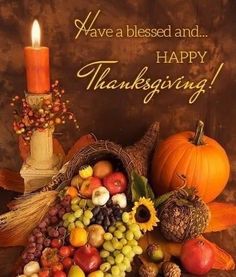 a thanksgiving card with a candle, pumpkins and gourds on the table