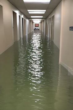 a flooded hallway with cars parked in it