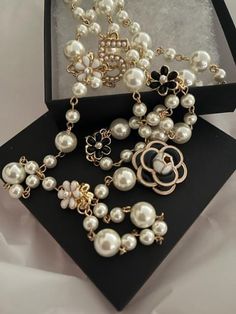 Stay on top of the latest fashion trends with our Luxury Long Multi-layer Flower Pearl Necklace. Featuring a stunning double-layer design with delicate pearls and a luxurious camellia charm, this necklace is a must-have for any style-savvy woman. With its elegant and versatile design, it also makes for a perfect gift for the special women in your life. Upgrade your jewelry collection with this trendy and timeless piece. This luxurious pearl layer necklace adorned with beautiful flowers made of p Luxury Pearl Embellished Necklace, Luxury Party Necklaces With Detachable Pendant, Luxury Rhinestone Necklace As Gift, Luxury Festive Necklace With Pearl Embellishments, Luxury Pearl Embellished Necklace For Gift, Luxury Party Necklace With Detachable Pendant, Luxury Pearl Necklace For Party, Luxury Festive Jewelry With Pearl Embellishments, Unique Luxury Beaded Necklaces For Wedding