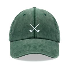 a green hat with two crossed golf clubs on the front and white stitching across the peak