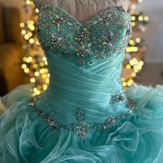 a dress on display in front of a christmas tree