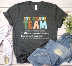 a t - shirt with the words 2nd grade team on it next to some jeans