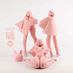 two pink figurines are standing next to each other