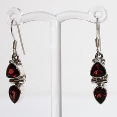 Make a statement with these elegant hand-crafted semi-precious stone earrings which feature red Garnet and rainbow Moonstone gemstones.  Stone: Garnet Colour: Red Metal: 925 Solid Sterling Silver  Drop Length: 3.5cm  Earring Width: 0.7cm Materials: Each one-of-a-kind piece of jewellery is lovingly hand crafted using top quality semi-precious natural gemstones and solid 925 sterling silver, so that you can treasure your piece for a lifetime.  Gift Boxes: each unique piece is also beautifully pack Elegant Jewelry With Garnet Natural Stones, Elegant Jewelry With Garnet And Natural Stones, Elegant Garnet Jewelry With Natural Stones, Classic Handmade Gemstones As Gifts, Classic Handmade Gemstones For Gifts, Handmade Classic Gemstones For Gifts, Classic Red Jewelry As A Gift, Red Gemstone Jewelry As Gift For Her, Formal Sterling Silver Gemstone Earrings