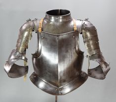 a metal armor is displayed on a stand