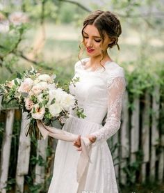 a woman in a white dress holding a bouquet