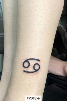 a person with a tattoo on their leg that has an astro sign tattooed on it