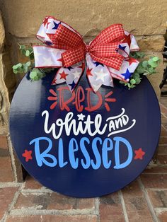 a blue sign with red, white and blue bows on it