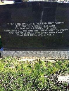 a black monument sitting on top of a lush green field