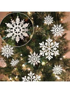 white snowflake ornaments hanging from a christmas tree