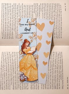 a bookmark with an image of a princess reading a book and hearts on it