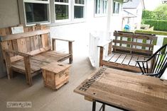 two wooden benches sitting on top of a porch next to a table with chairs around it