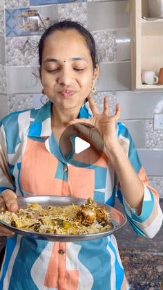 a woman holding a plate with food on it