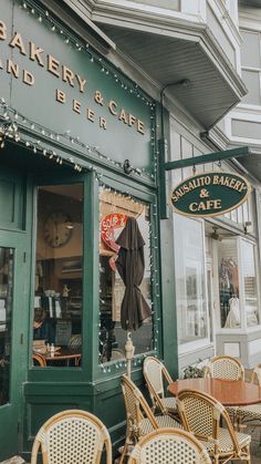 the outside of a bakery and cafe with many tables and chairs in front of it